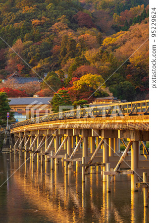 Autumn in Saga-Arashiyama, Kyoto Togetsukyo Bridge and autumn leaves illuminated by the morning sun 95229624
