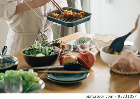 A woman serving fried chicken A woman serving fried chicken 95231857