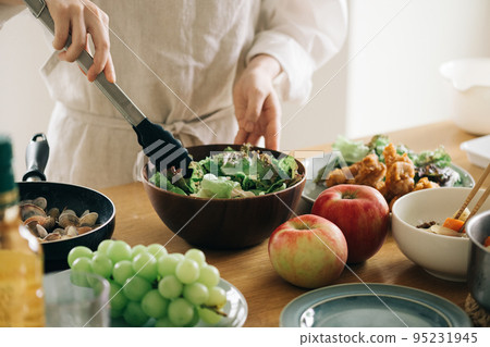 A woman making a salad 95231945
