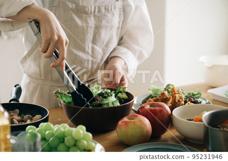 A woman making a salad A woman making a salad 95231946