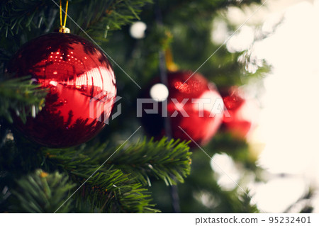 Christmas balls on a huge Christmas tree. The concept of a new year and Christmas. Front view. Christmas balls on a huge Christmas tree. The concept of a new year and Christmas. Front view. 95232401