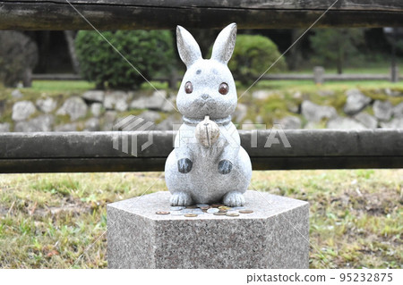 A stone statue of a rabbit with a bell at Izumo Taisha Shrine A stone statue of a rabbit with a bell at Izumo Taisha Shrine 95232875