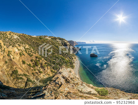 Summer seascape with Fiolent rocks formation on the coast of Sevastopol. view on cape in the sea, clear azure water, calm hot day. Copy space. The concept of calmness, silence and unity with nature. Summer seascape with Fiolent rocks formation on the coast of Sevastopol. view on cape in the sea, clear azure water, calm hot day. Copy space. The concept of calmness, silence and unity with nature. 95232968