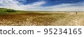 dried lake with walking woman on steppe near the Sea of Azov, Ukraine 95234165