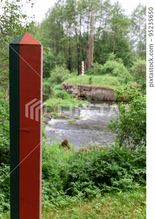 Border poles on the border line between Poland and Belarus 95235650