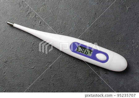 Medical electronic thermometer on a black background. High temperature. The concept of diagnosis of diseases. Medical electronic thermometer on a black background. High temperature. The concept of diagnosis of diseases. 95235707