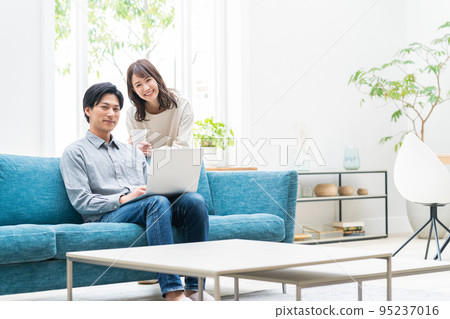 Couple couple lifestyle living room computer 95237016