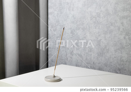 Aromatic stick aroma therapy burning in grey modern interior room, atmosphere and minimalistic composition Aromatic stick aroma therapy burning in grey modern interior room, atmosphere and minimalistic composition 95239566
