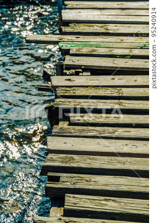 Day sunny view of woods composing empty promenade by a calm sea. 95240914