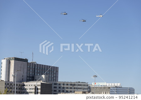 Helicopter. Airplane. Military vehicle. Spanish Air Force on the day of the National Holiday of October 12 flying over the streets of the city of Madrid. MADRID, SPAIN - OCTOBER 12, 2022. 95241214