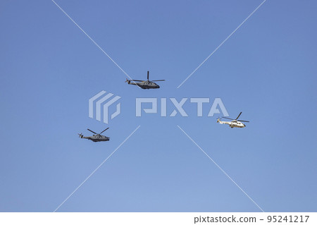 Helicopter. Airplane. Military vehicle. Spanish Air Force on the day of the National Holiday of October 12 flying over the streets of the city of Madrid. MADRID, SPAIN - OCTOBER 12, 2022. Helicopter. Airplane. Military vehicle. Spanish Air Force on the day of the National Holiday of October 12 flying over the streets of the city of Madrid. MADRID, SPAIN - OCTOBER 12, 2022. 95241217