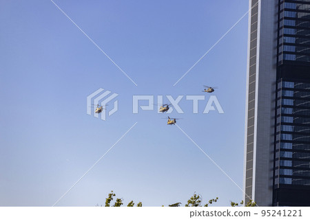 Helicopter. Airplane. Military vehicle. Spanish Air Force on the day of the National Holiday of October 12 flying over the streets of the city of Madrid. MADRID, SPAIN - OCTOBER 12, 2022. Helicopter. Airplane. Military vehicle. Spanish Air Force on the day of the National Holiday of October 12 flying over the streets of the city of Madrid. MADRID, SPAIN - OCTOBER 12, 2022. 95241221