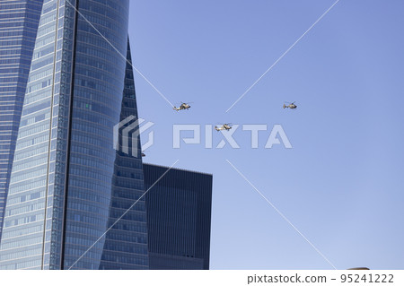 Helicopter. Airplane. Military vehicle. Spanish Air Force on the day of the National Holiday of October 12 flying over the streets of the city of Madrid. MADRID, SPAIN - OCTOBER 12, 2022. Helicopter. Airplane. Military vehicle. Spanish Air Force on the day of the National Holiday of October 12 flying over the streets of the city of Madrid. MADRID, SPAIN - OCTOBER 12, 2022. 95241222