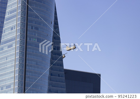 Helicopter. Airplane. Military vehicle. Spanish Air Force on the day of the National Holiday of October 12 flying over the streets of the city of Madrid. MADRID, SPAIN - OCTOBER 12, 2022. Helicopter. Airplane. Military vehicle. Spanish Air Force on the day of the National Holiday of October 12 flying over the streets of the city of Madrid. MADRID, SPAIN - OCTOBER 12, 2022. 95241223