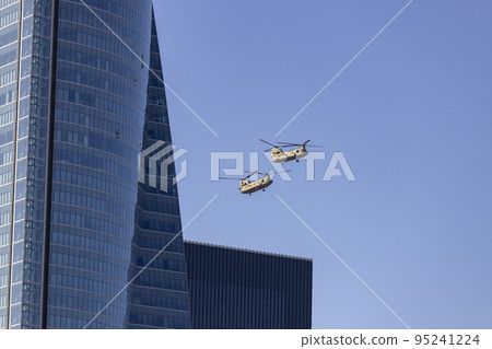 Helicopter. Airplane. Military vehicle. Spanish Air Force on the day of the National Holiday of October 12 flying over the streets of the city of Madrid. MADRID, SPAIN - OCTOBER 12, 2022. 95241224