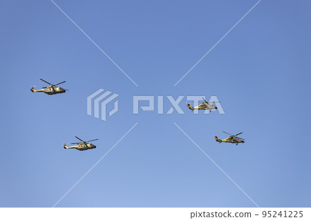 Helicopter. Airplane. Military vehicle. Spanish Air Force on the day of the National Holiday of October 12 flying over the streets of the city of Madrid. MADRID, SPAIN - OCTOBER 12, 2022. 95241225