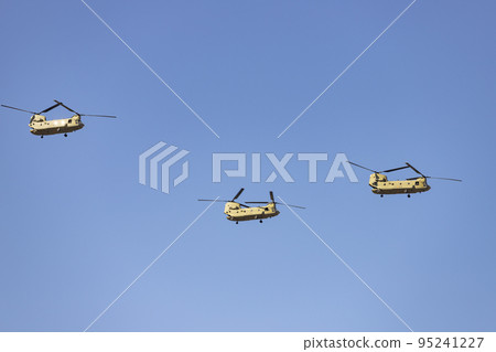 Helicopter. Airplane. Military vehicle. Spanish Air Force on the day of the National Holiday of October 12 flying over the streets of the city of Madrid. MADRID, SPAIN - OCTOBER 12, 2022. 95241227