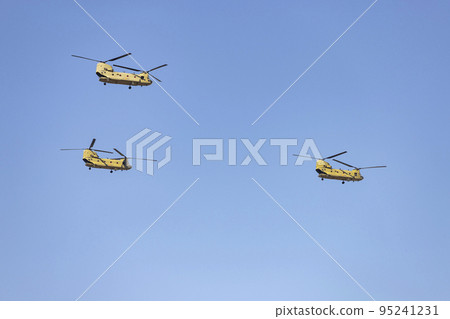 Helicopter. Airplane. Military vehicle. Spanish Air Force on the day of the National Holiday of October 12 flying over the streets of the city of Madrid. MADRID, SPAIN - OCTOBER 12, 2022. 95241231