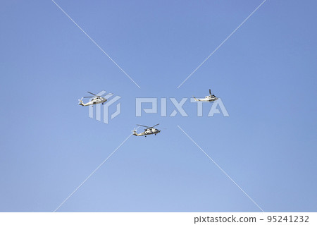 Helicopter. Airplane. Military vehicle. Spanish Air Force on the day of the National Holiday of October 12 flying over the streets of the city of Madrid. MADRID, SPAIN - OCTOBER 12, 2022. Helicopter. Airplane. Military vehicle. Spanish Air Force on the day of the National Holiday of October 12 flying over the streets of the city of Madrid. MADRID, SPAIN - OCTOBER 12, 2022. 95241232