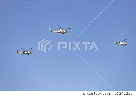 Helicopter. Airplane. Military vehicle. Spanish Air Force on the day of the National Holiday of October 12 flying over the streets of the city of Madrid. MADRID, SPAIN - OCTOBER 12, 2022. Helicopter. Airplane. Military vehicle. Spanish Air Force on the day of the National Holiday of October 12 flying over the streets of the city of Madrid. MADRID, SPAIN - OCTOBER 12, 2022. 95241233