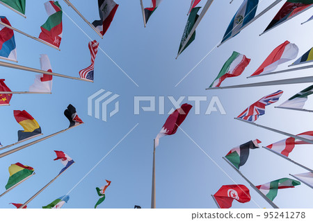 Doha, Qatar - October 9, 2022: The Flag Plaza, displays 119 flags from countries with authorized diplomatic missions, including flags of the European Union, the United Nation and the GCC. 95241278