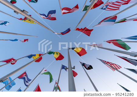 Doha, Qatar - October 9, 2022: The Flag Plaza, displays 119 flags from countries with authorized diplomatic missions, including flags of the European Union, the United Nation and the GCC. 95241280