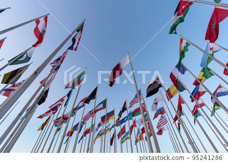 Doha, Qatar - October 9, 2022: The Flag Plaza, displays 119 flags from countries with authorized diplomatic missions, including flags of the European Union, the United Nation and the GCC. 95241286