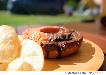 Chocolate old-fashioned donuts and potato chips to eat at camp Chocolate old-fashioned donuts and potato chips to eat at camp 95242146