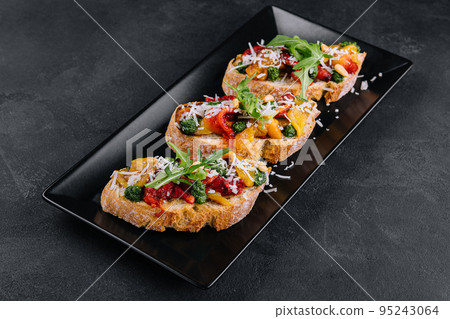 bruschetta with roasted peppers, pesto and parmesan cheese bruschetta with roasted peppers, pesto and parmesan cheese 95243064