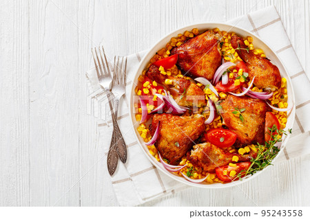 roast chicken with corn and tomatoes on plate 95243558