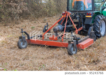 It is common in autumn to use tractor to trim or remove small branches that grow on ground during season It is common in autumn to use tractor to trim or remove small branches that grow on ground during season 95243766