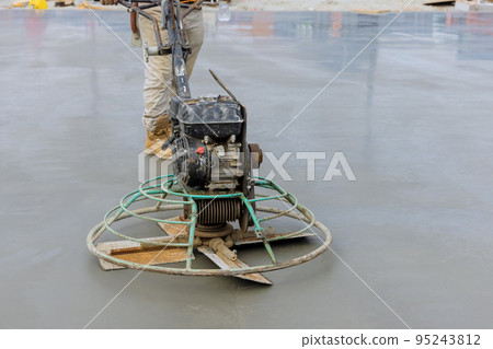 An operation to polish and level cement screed mortar floor on construction site is performed as follows An operation to polish and level cement screed mortar floor on construction site is performed as follows 95243812