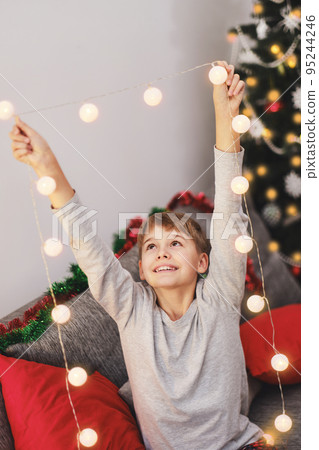 Excited Christmas boy rejoices in the Christmas holidays. Excited Christmas boy rejoices in the Christmas holidays. 95244246