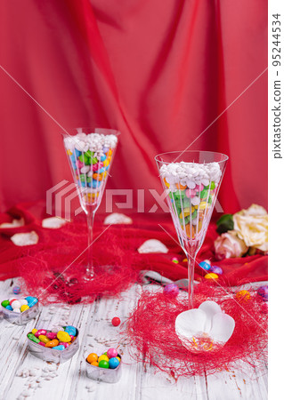 colorful sweets in champagne glasses colorful sweets in champagne glasses 95244534