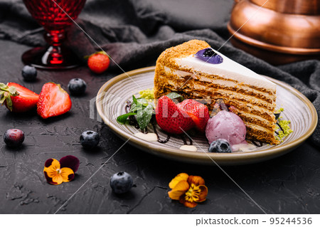 piece of multi-layered cake decorated with mixed berries piece of multi-layered cake decorated with mixed berries 95244536