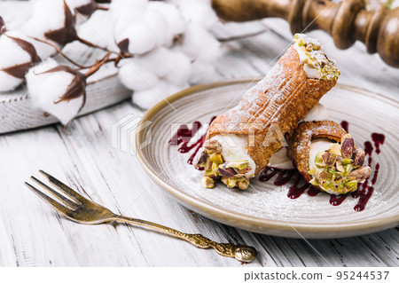 Traditional italian dessert cannoli siciliani on plate 95244537
