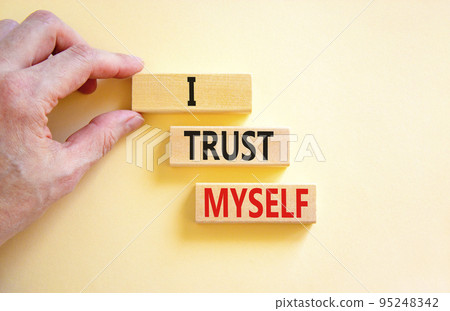 I trust myself symbol. Concept words I trust myself on wooden blocks. Businessman hand. Beautiful white table white background. Business, psychological and I trust myself concept. Copy space. I trust myself symbol. Concept words I trust myself on wooden blocks. Businessman hand. Beautiful white table white background. Business, psychological and I trust myself concept. Copy space. 95248342