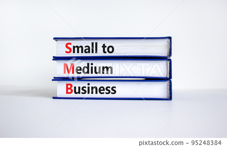 SMB small to medium business symbol. Words SMB small to medium business on books on a beautiful white table, white background. Business and SMB small to medium business concept. Copy space. 95248384
