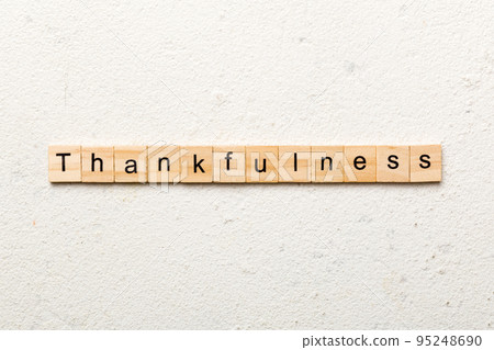 Thankfulness word written on wood block. Thankfulness text on cement table for your desing, concept Thankfulness word written on wood block. Thankfulness text on cement table for your desing, concept 95248690
