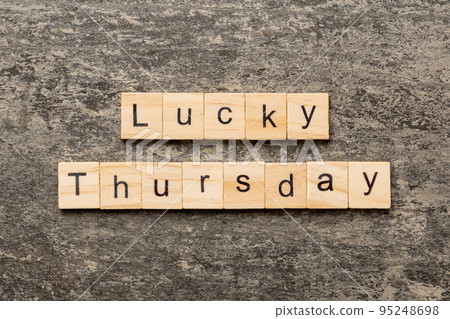 lucky thursday word written on wood block. lucky thursday text on cement table for your desing, concept 95248698