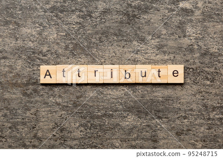ATTRIBUTE word written on wood block. ATTRIBUTE text on cement table for your desing, concept 95248715