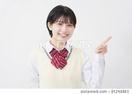 High school student pointing to the right White background 95248863