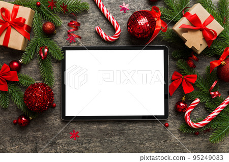 Top view of empty tablet on Christmas background made of new year decorand festive decorations. New year holiday concept. Mockup 95249083