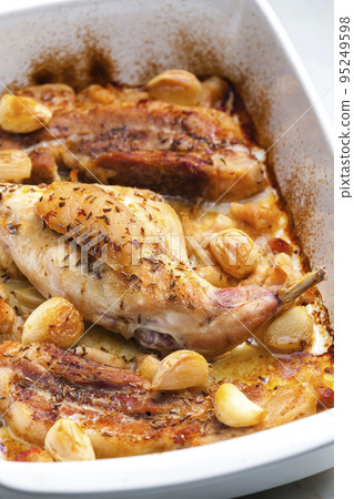 baked rabbit leg with garlic and bacon baked rabbit leg with garlic and bacon 95249598