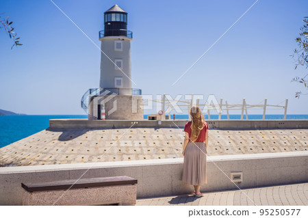 Woman tourist enjoying the views of Architecture and luxury yachts in Lustica Bay, Montenegro. Travel around Montenegro concept. Go Everywhere Woman tourist enjoying the views of Architecture and luxury yachts in Lustica Bay, Montenegro. Travel around Montenegro concept. Go Everywhere 95250577
