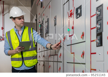 Electrical engineer working in control room.  95251143