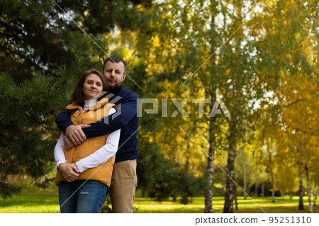 happy adult family traditional couple in autumn forest stands embracing happy adult family traditional couple in autumn forest stands embracing 95251310