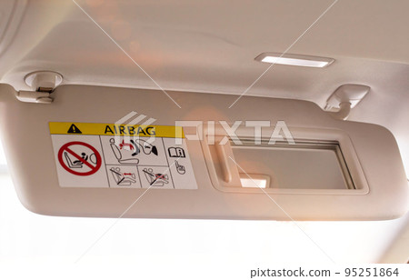 Modern car sun visor with mirror, close-up. Sunshield 95251864