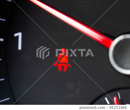 Red man on the dashboard in the car. The concept of an unfastened seat belt in a car, the safety of the driver and passenger. Close-up Red man on the dashboard in the car. The concept of an unfastened seat belt in a car, the safety of the driver and passenger. Close-up 95251866