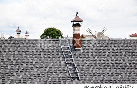 shingle roof. Old method of making roofs from wood, background. Roof ladder and chimney, architectural 95251876